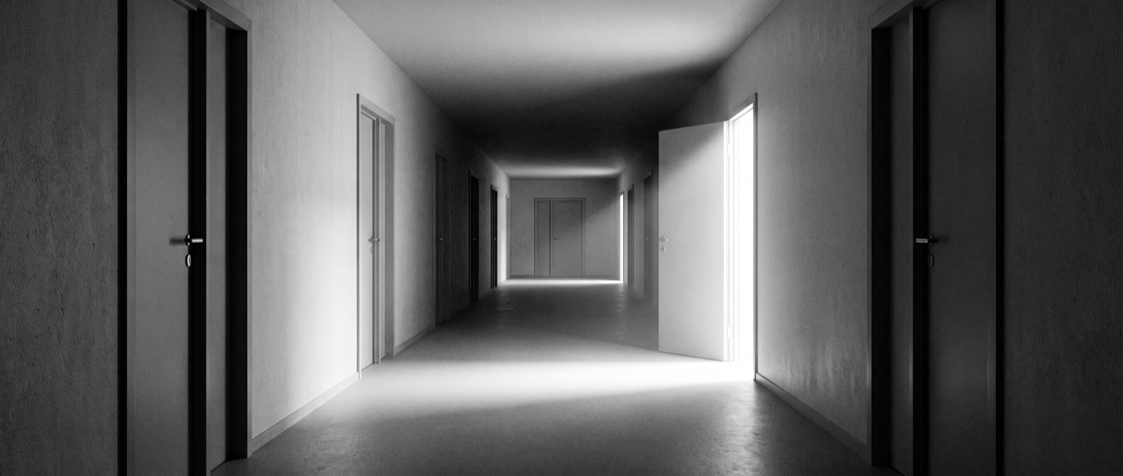 A corridor of closed doors with one standing open